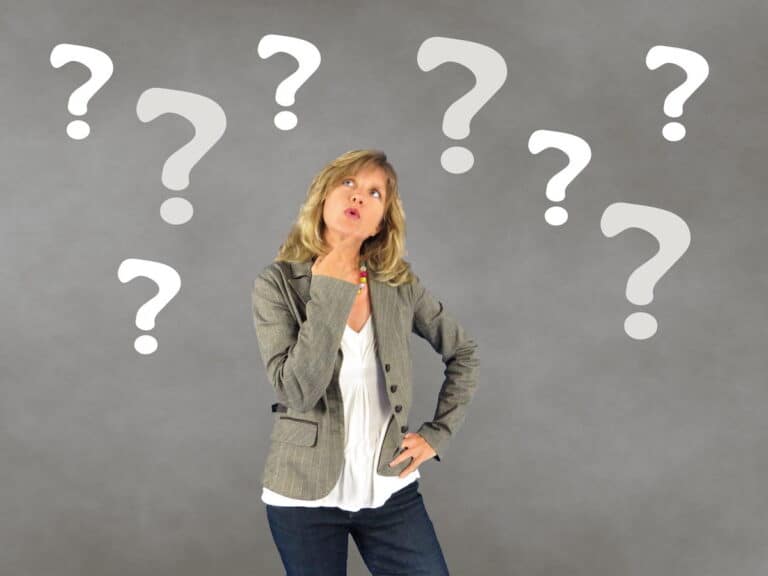 Woman with question marks around her thining about HRT