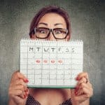 woman-holding-calendar-to-show-progesterone-cycle