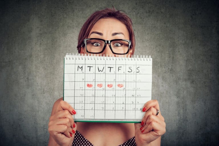 woman-holding-calendar-to-show-progesterone-cycle