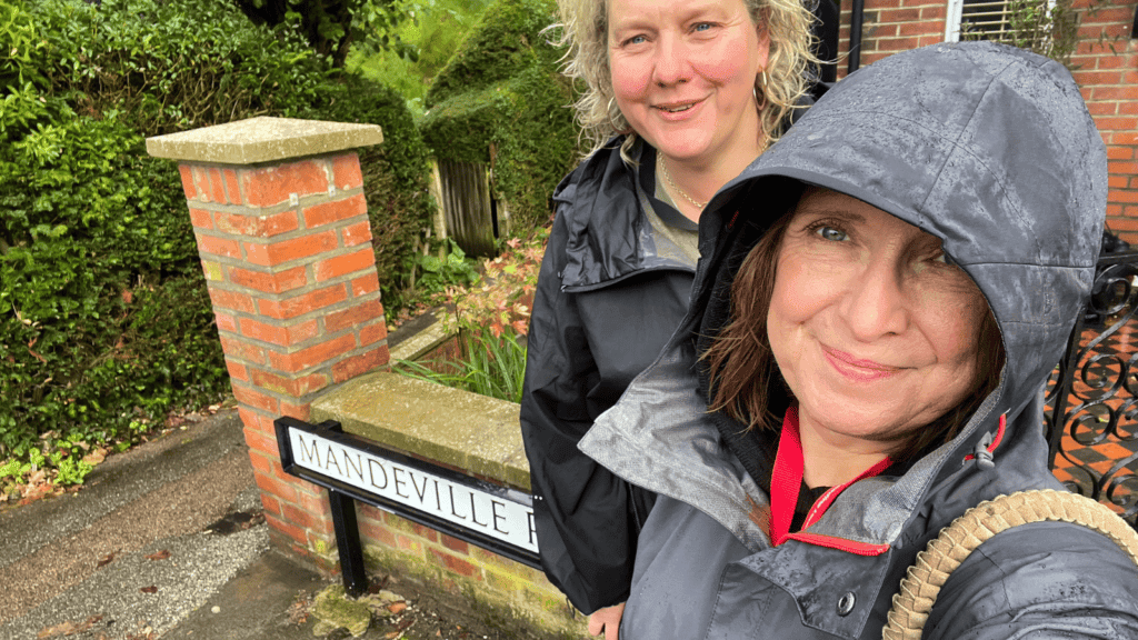 Two women standing in a street in the rain
